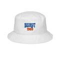 White Monani bucket hat with blue and orange Beirut 1969 lettering