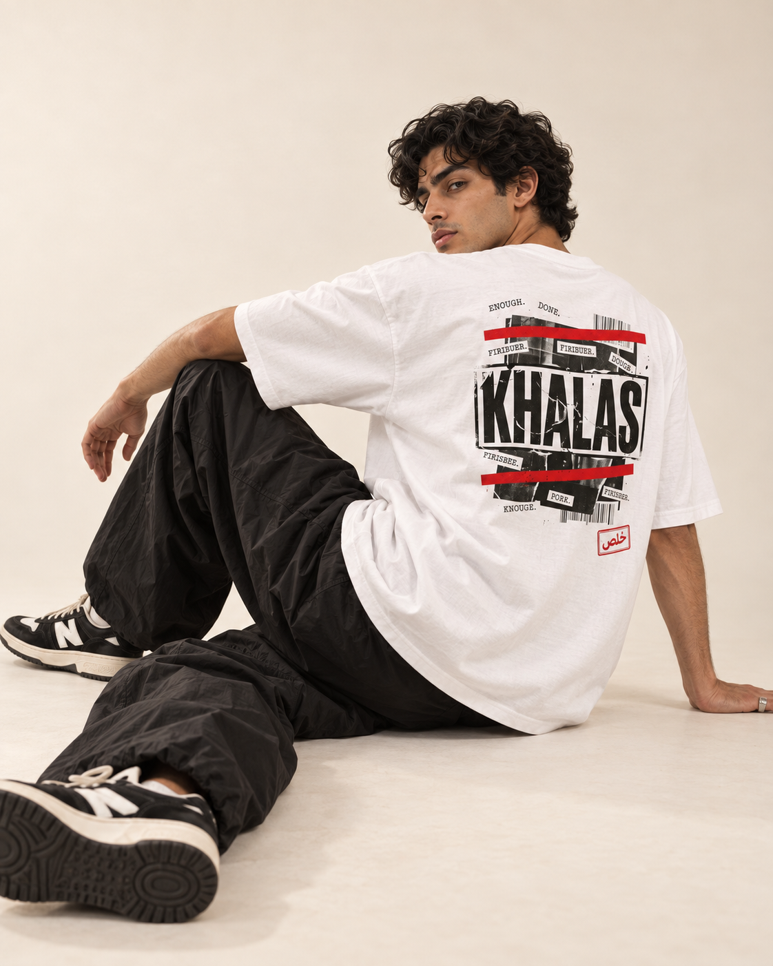 Model wearing a white Monani Khalas T-shirt, showing the black and red back graphic