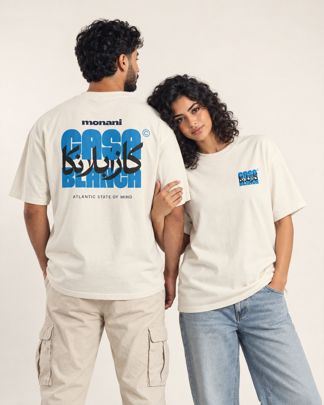 Two models showing the blue Casablanca front and back graphics on ivory Monani T-shirts