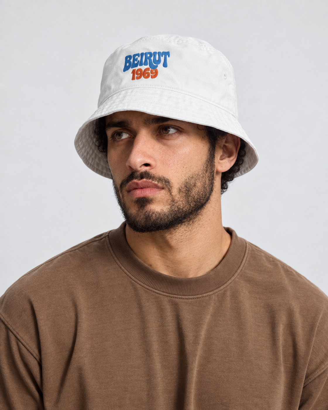 Model wearing the Monani Beirut 1969 white bucket hat, portrait view