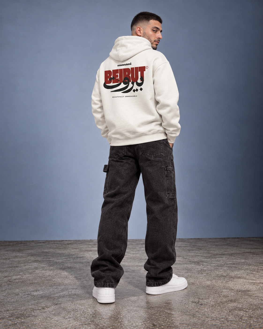 Model wearing the ivory Monani Beirut Hoodie, back studio view