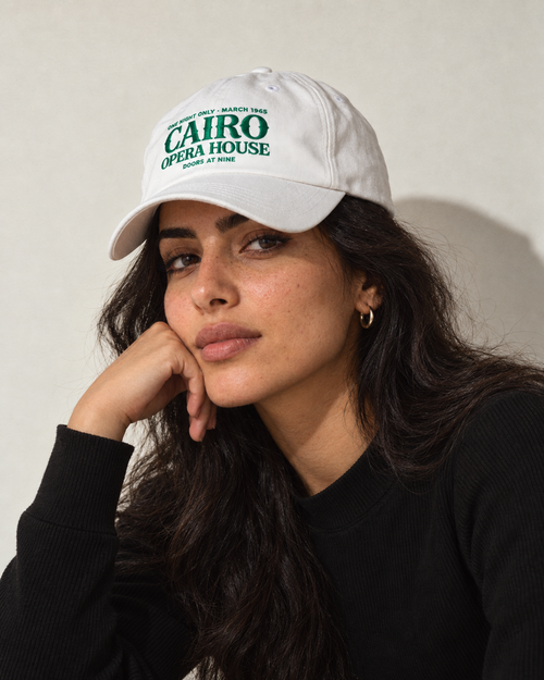 Model wearing the Monani Cairo Opera House white cap