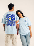 Two models showing the front and blue evil eye back graphic on a light blue Monani Mahsood T-shirt
